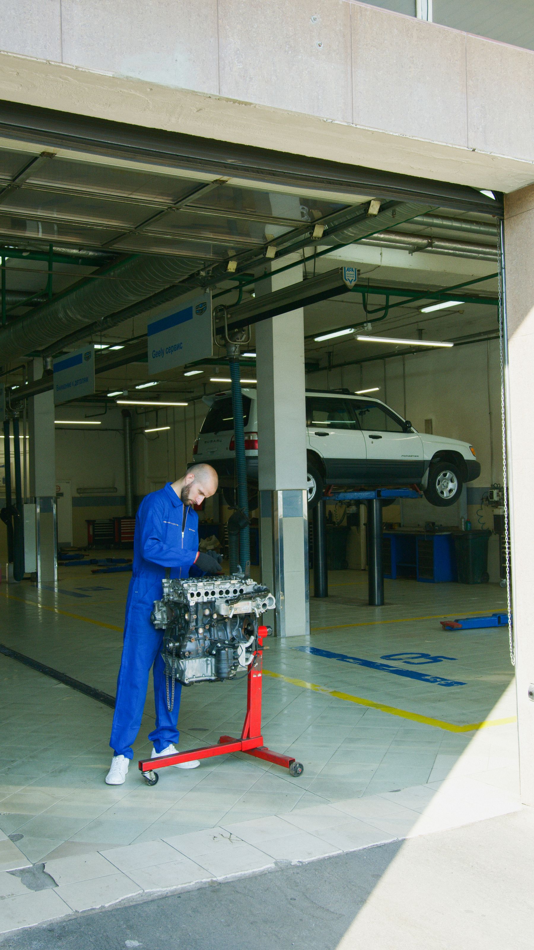 Mechanik pracujący przy zdemontowanym silniku